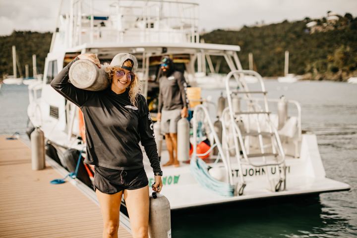 a person standing next to a body of water