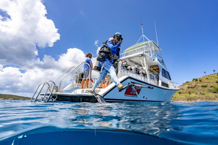 a man riding on the back of a boat in the water