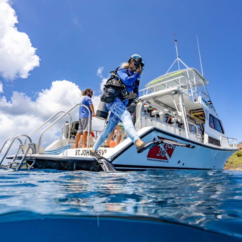 a man riding on the back of a boat in the water