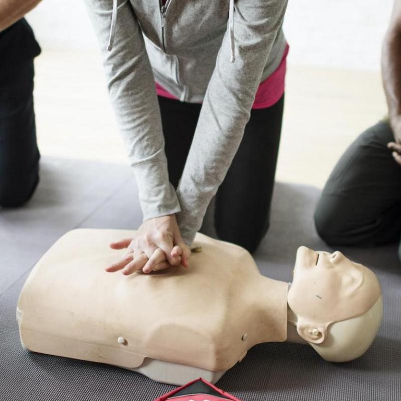 a group of people sitting on a suitcase