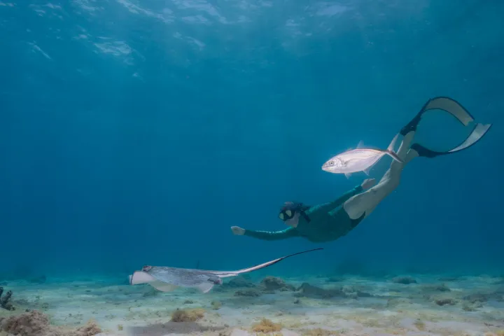 a man flying through the air over a body of water