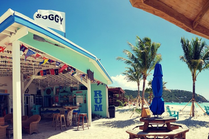 a group of people sitting at a table in front of a building